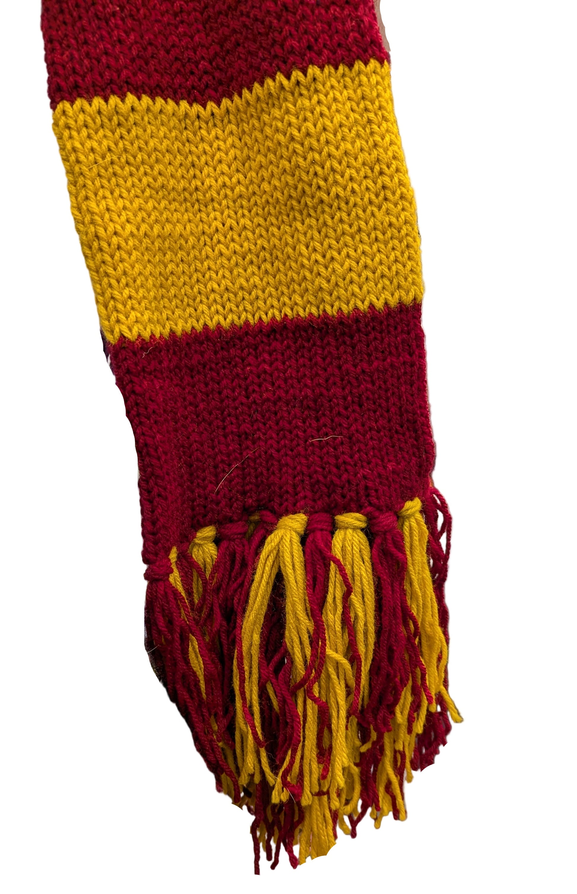 Knitted scarf with red and yellow stripes and tassels in a store setting.